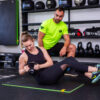 Trening z trenerem-personalnym a także trening z trenerem personalnym w parach w Gdańsku. Trener daje wskazówki podopiecznemu.